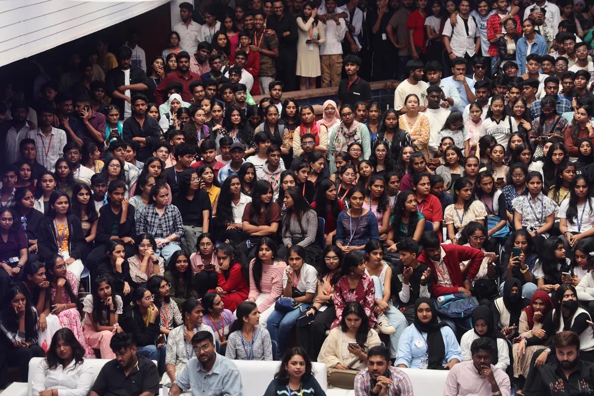 A packed crowd of students in the atrium during an event.