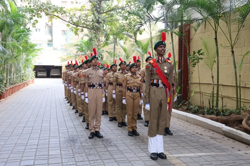 NCC cadets standing in formation on the campus walkway.